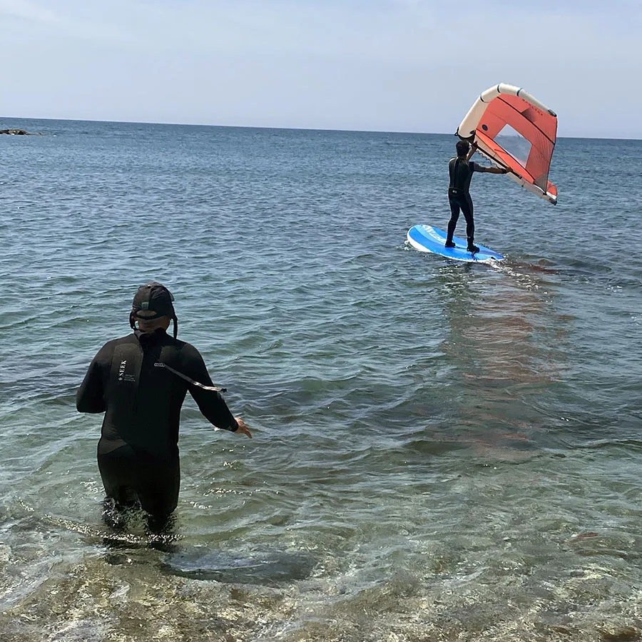 Clase de iniciación de wing foil con instructor dentro del agua